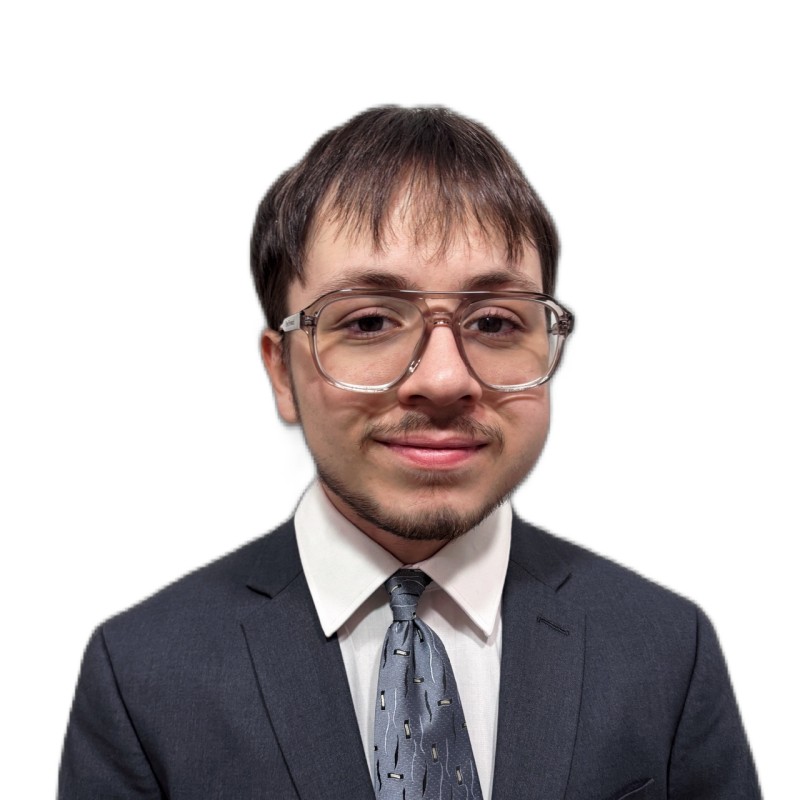 Headshot of Diego Gonzalez Alicata wearing a gray suit and tie