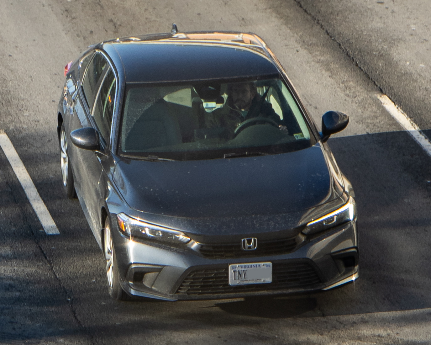 Silver eleventh-generation Honda Civic sedan parked on a street, front three-quarter view