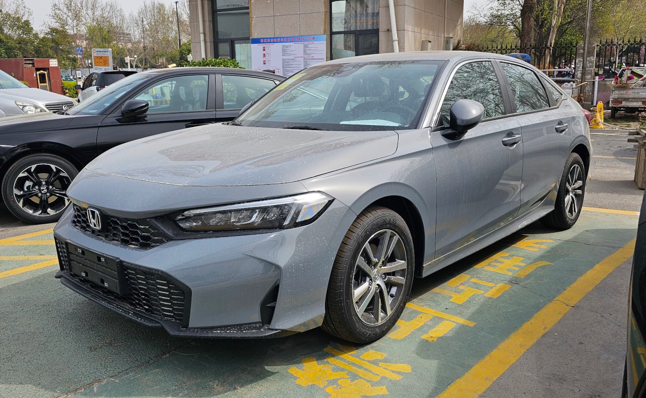 Refreshed eleventh-generation Honda Civic sedan in dark paint, front view